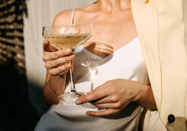 Wealthy-woman-wearing-cream-holding-champagne-glass